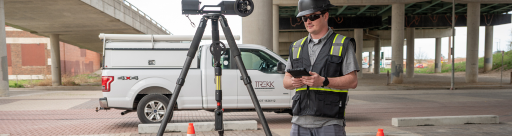 TREKK360 operator running a manhole inspection from the surface beside a work truck