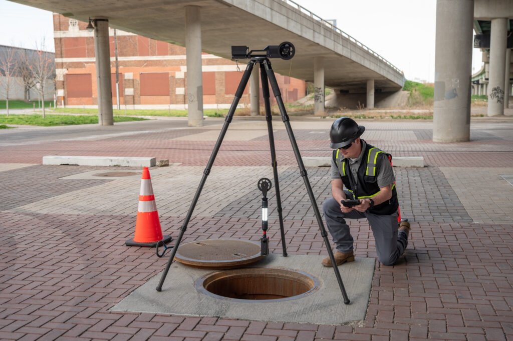 Operator reviewing TREKK360 data on a tablet next to the tripod