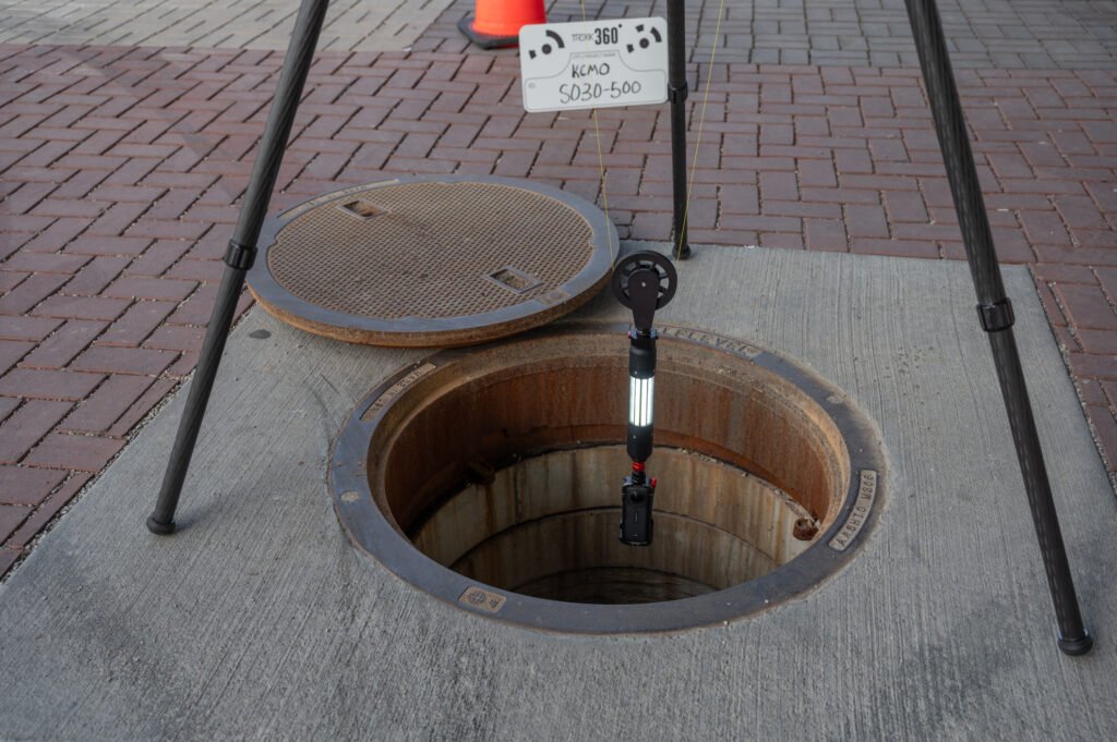 Overhead view of the TREKK360 camera entering a manhole