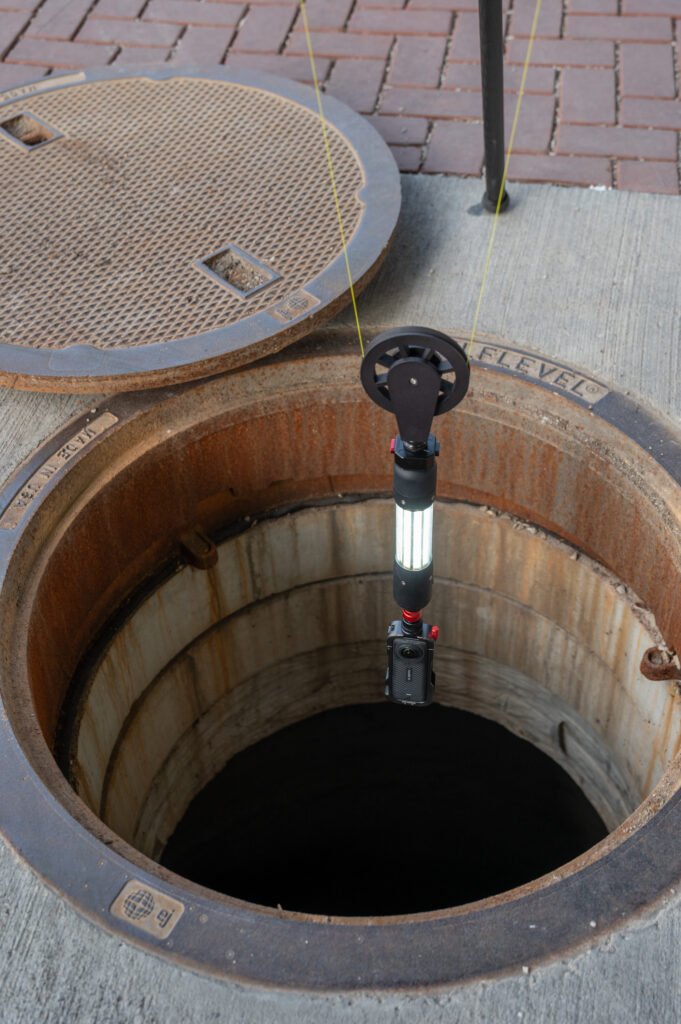TREKK360 camera descending into a manhole