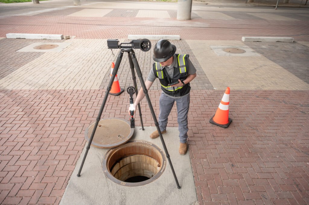 TREKK360 tripod and camera over a manhole on a brick street